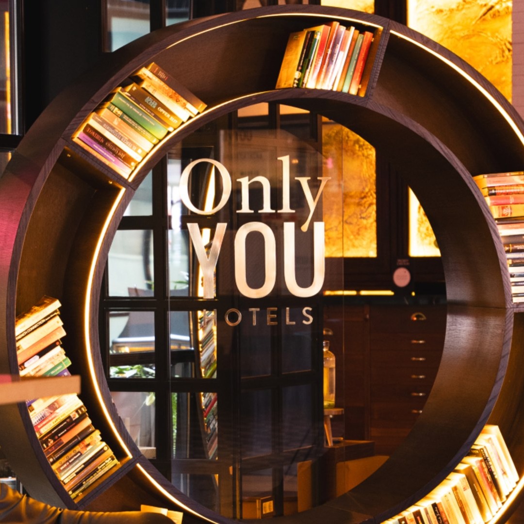 estantería de Only You Hotels, con forma circular y luces led integradas, en un espacio común de uno de sus hoteles.