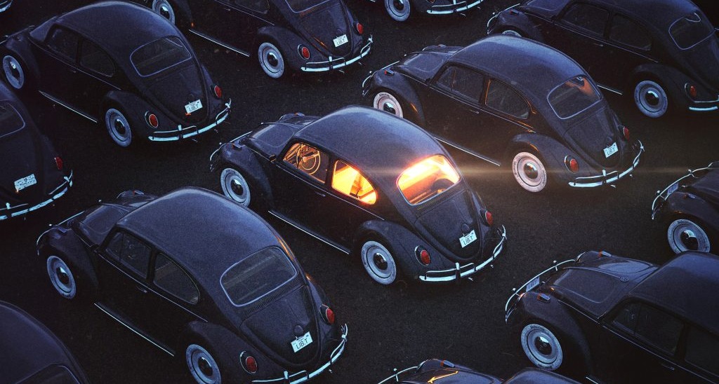 Coches antiguos negros, uno de ellos arroja luz