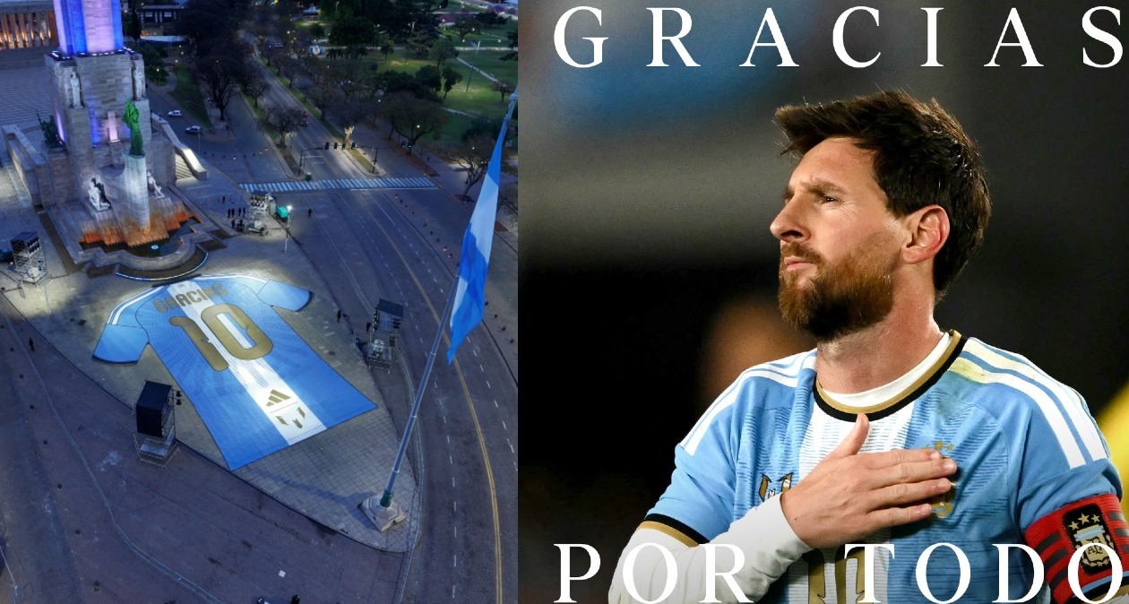 La camiseta gigante en un lado y al otro, Messi con la mano en el escudo