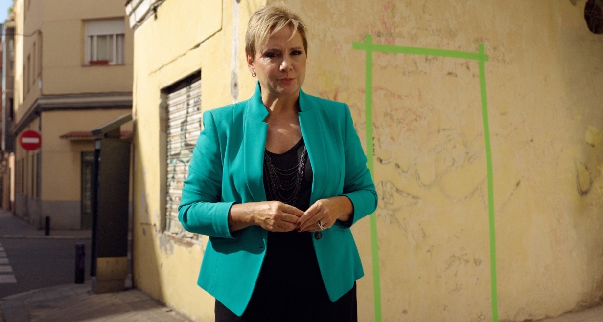 Gloria Serra frente a una pared con una puerta pintada