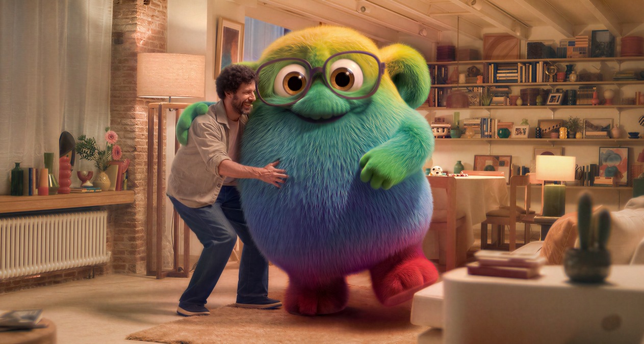 Un hombre abrazando a la mascota Totie en el salón