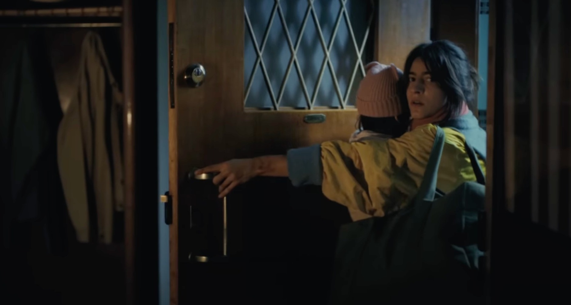 Mujer con un niño en brazos se va de casa